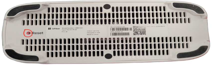 Bottom of Wi-Fi mesh extender with reset button highlighted